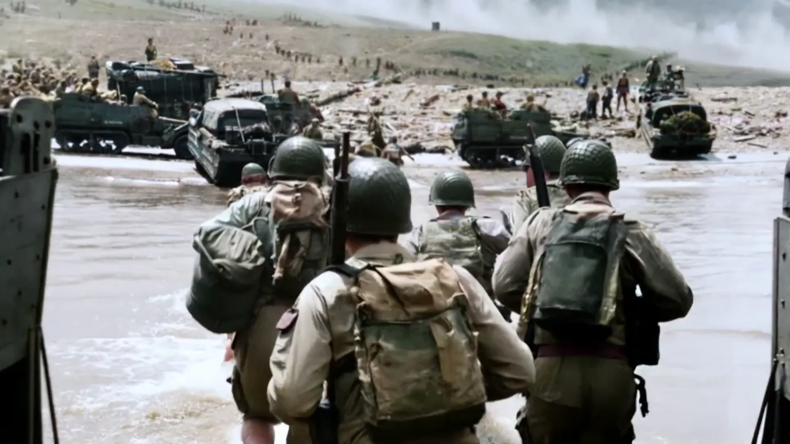 Soldiers landing on a beach from landing craft
