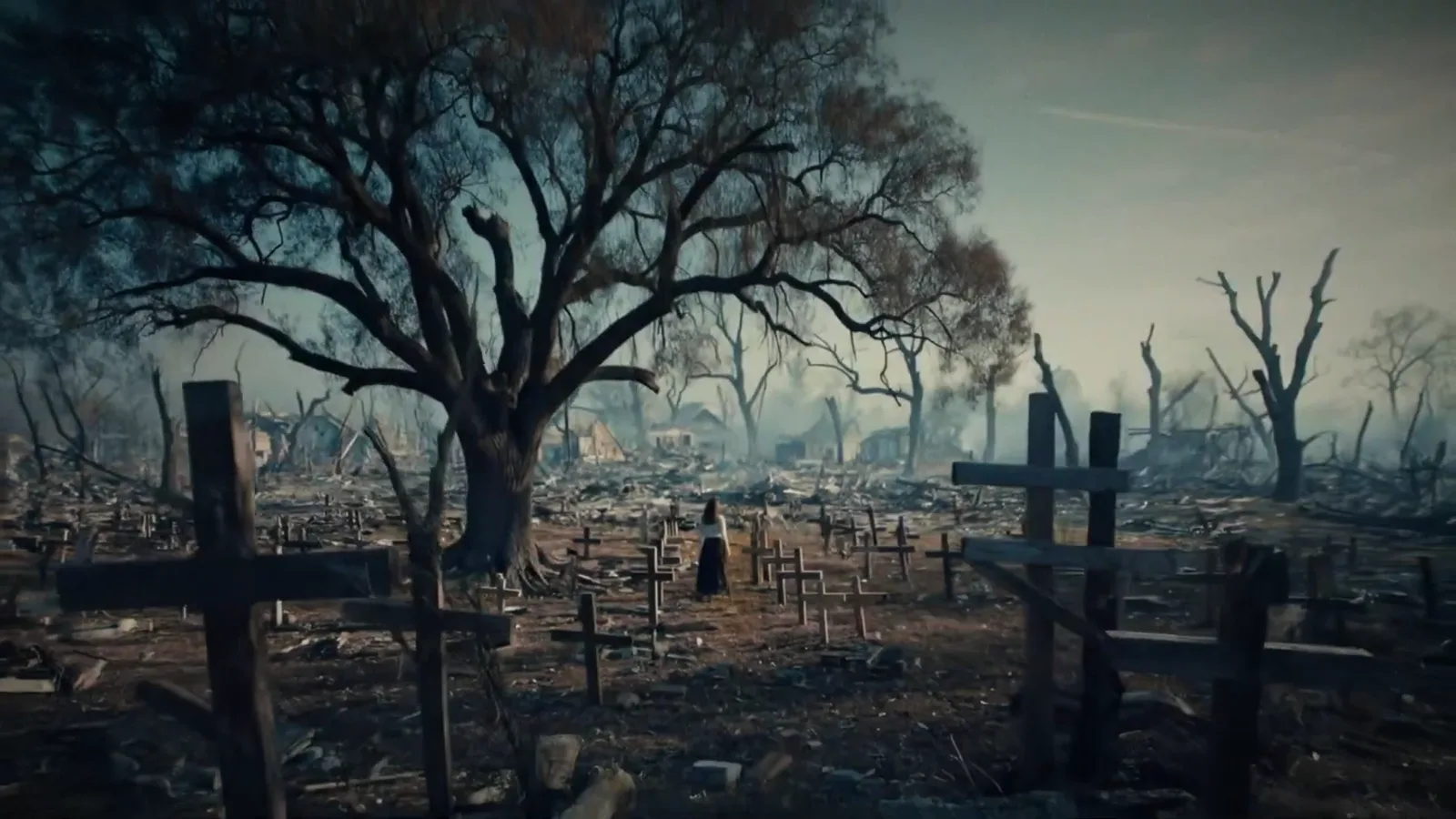 A ruined cemetery with wooden crosses