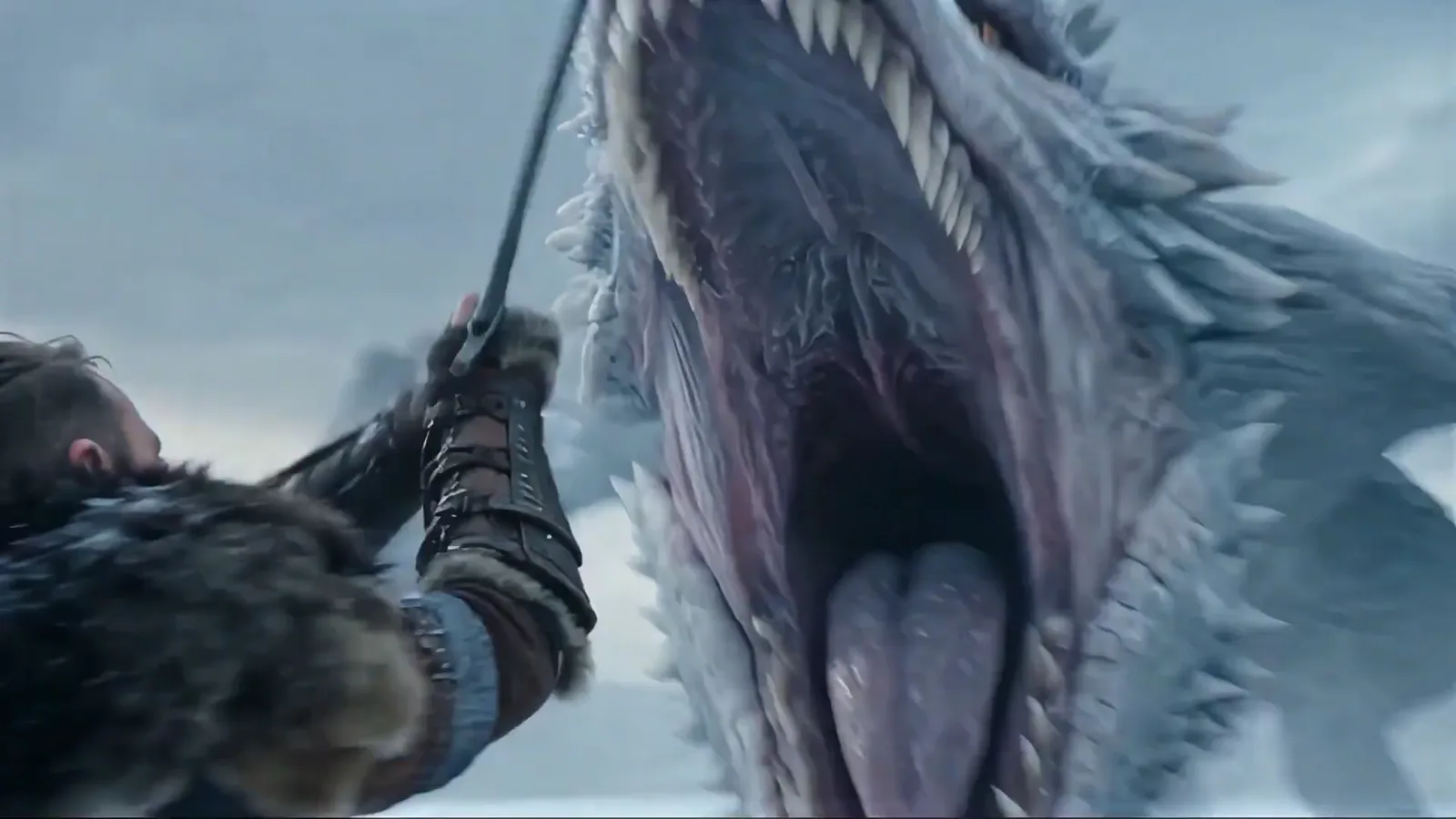A warrior with a sword facing the jaws of an ice dragon