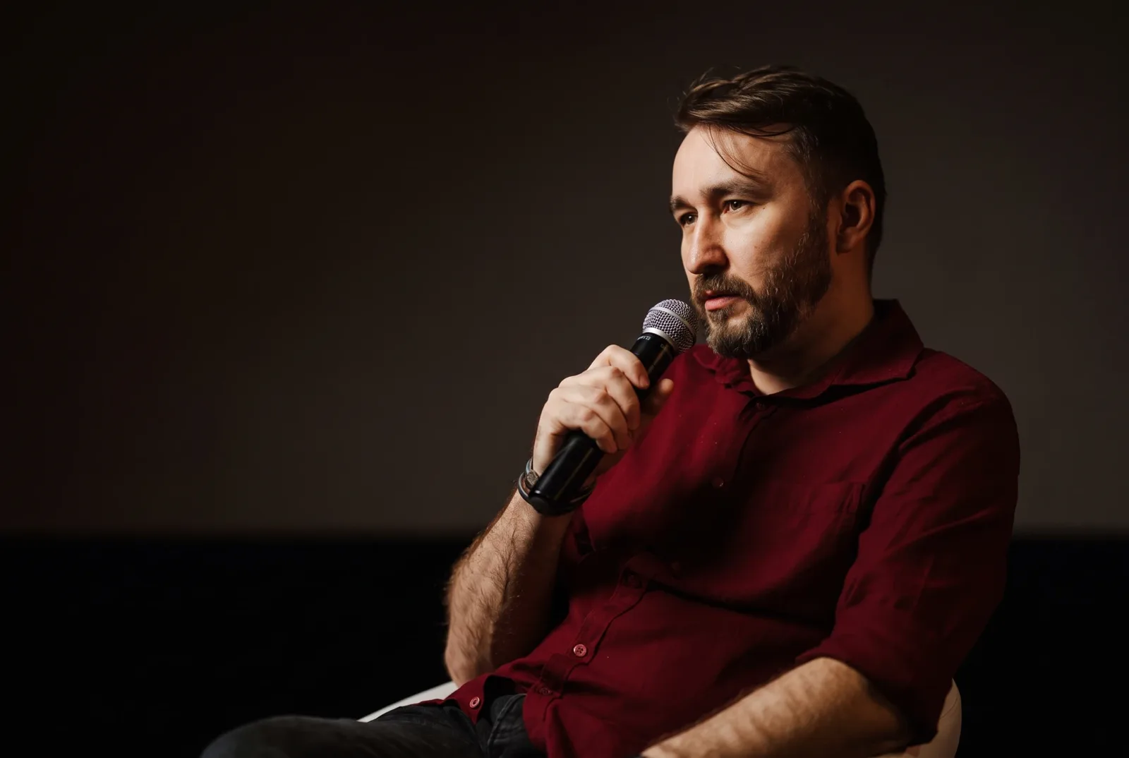 Krystian Wydro speaking into a microphone at IAB HowTo: AI Made Me Do It 2026